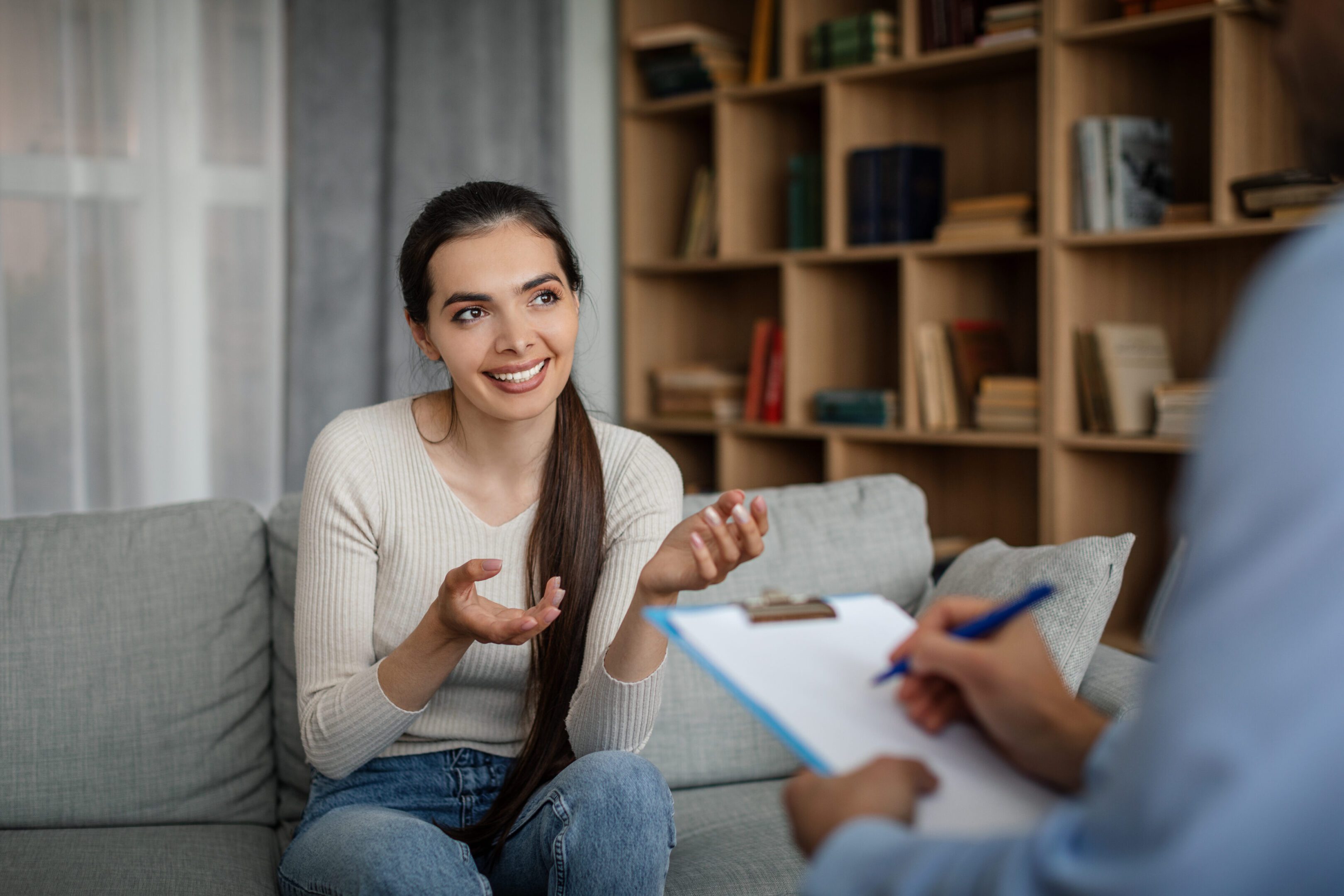 Woman talking to therapist on couch.
