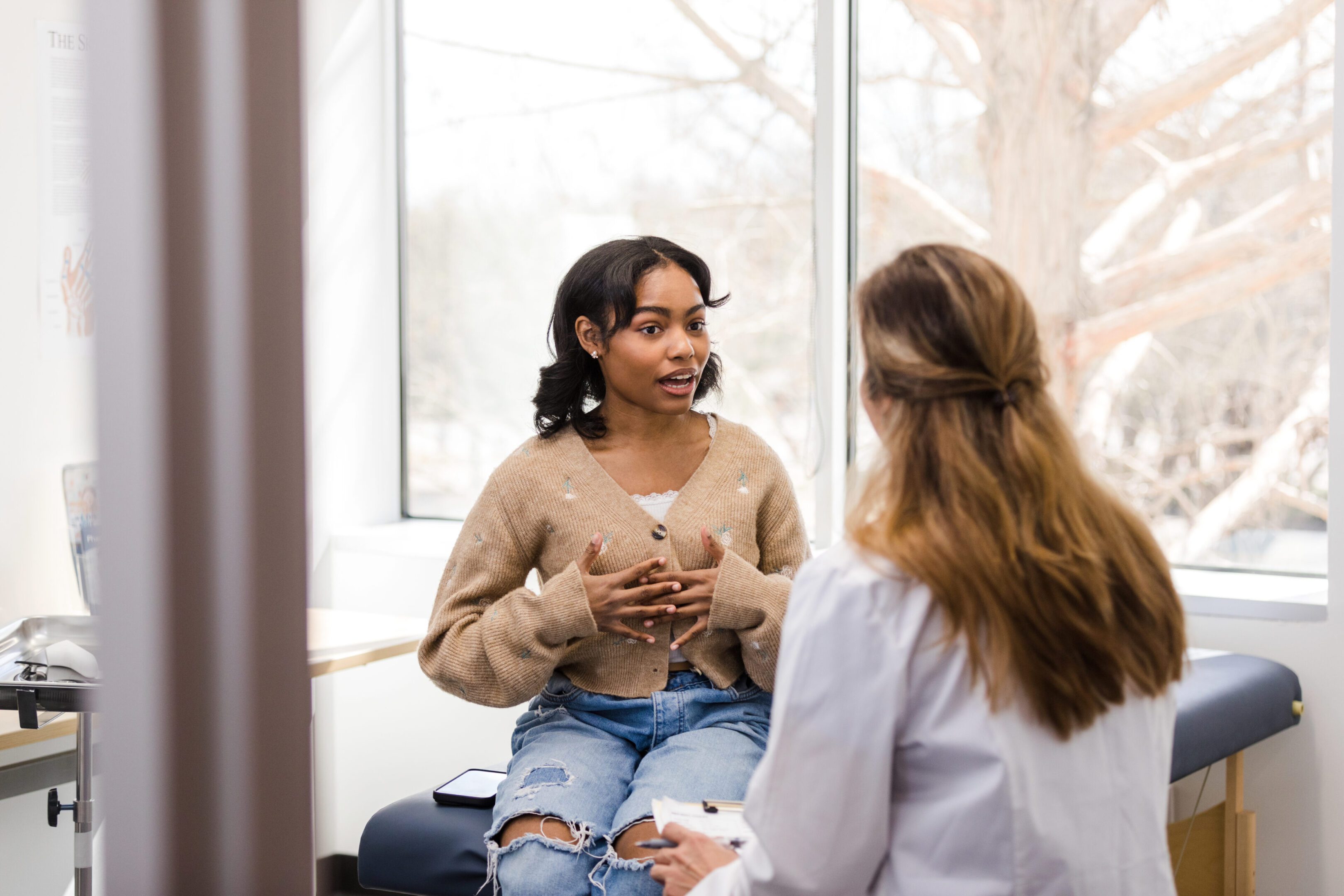 Patient consulting with a healthcare professional.