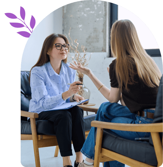 Two women having a conversation in office.