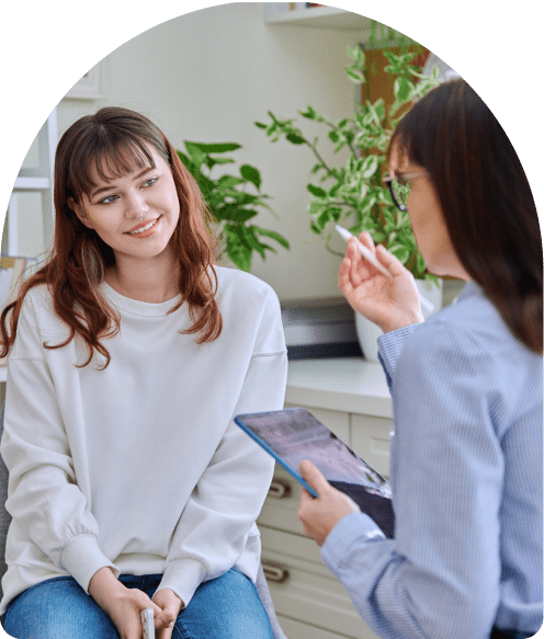 Two women talking in a casual setting.